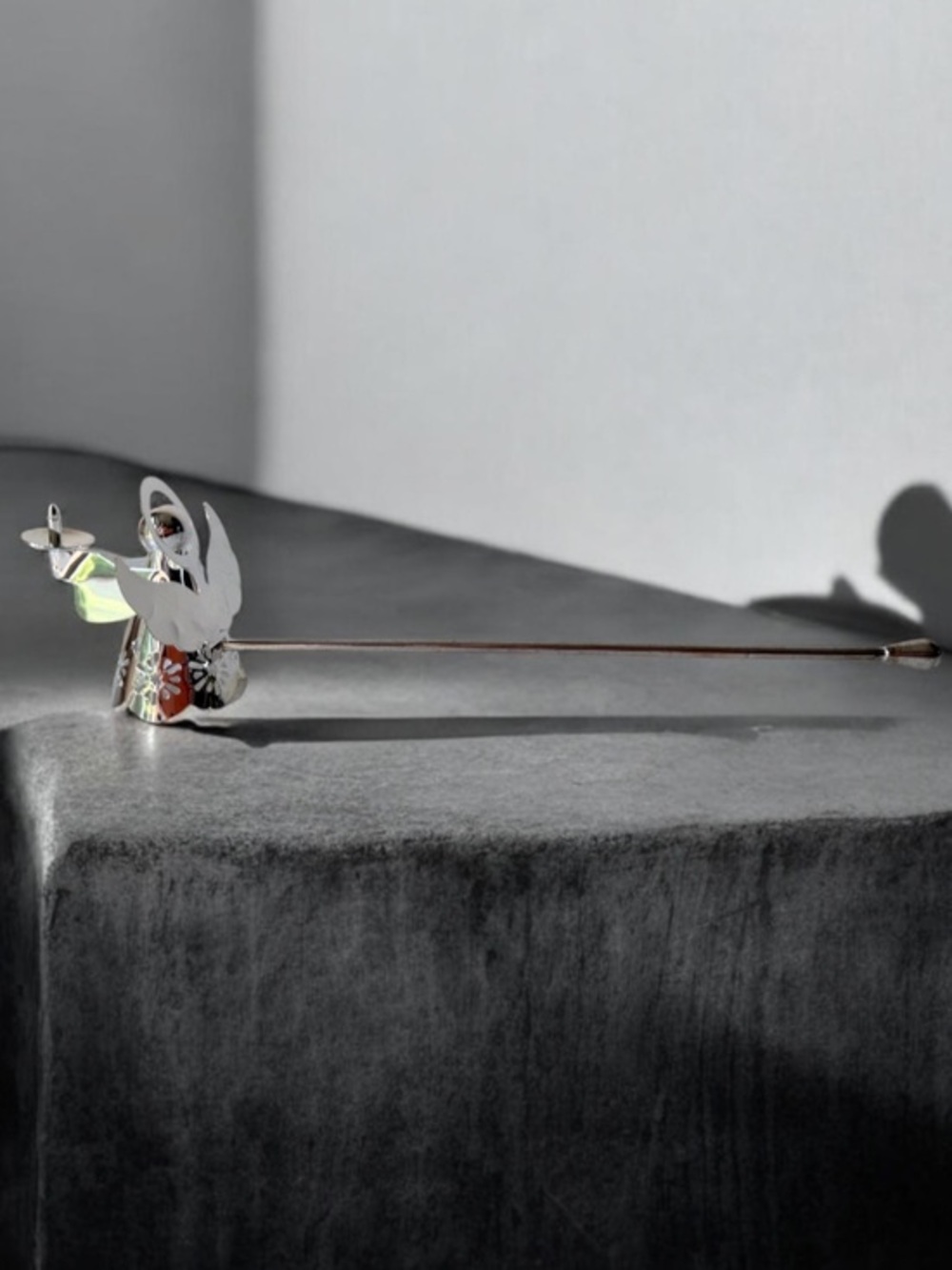 silver-tone angel candle snuffer features intricate, cutout wing and robe